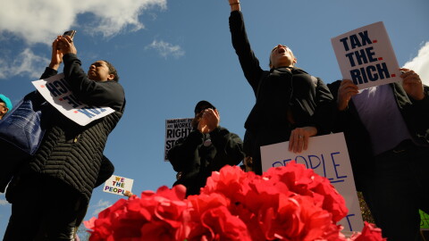 FILE: Rally-goers chant outside the Connecticut State Capitol with a basket of red poppies, which protestors were distributing “honoring working-class lives lost in imperialist wars.” Hundreds marched and rallied in downtown Hartford, May 01, 2026, the delivered a letter to Governor Ned Lamont’s office calling for a state budget that prioritizes investments in “housing, healthcare, public education, climate justice, and fair union contracts.”