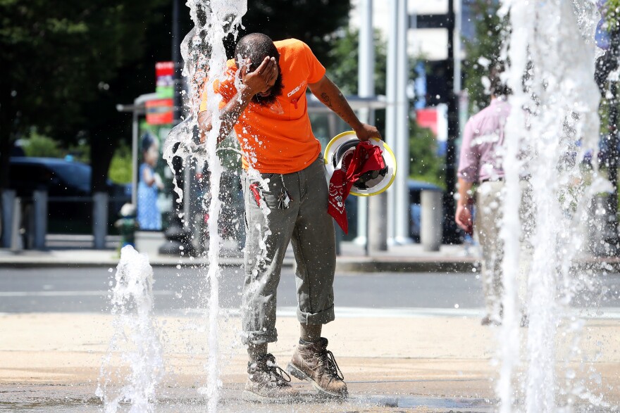 WASHINGTON, DC - JULY 19: A construction worker stops to cool off in the water fountains at Canal Park, on July 19, 2019 in Washington, DC. An excessive heat warning has been issued for the Washington area as temperatures approach triple digits. (Photo by Mark Wilson/Getty Images)