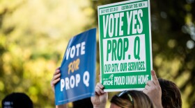 Supporters of the City of Austin’s Proposition Q hold signs during a press conference on Tuesday, Sept. 30, 2025, at Parque Zaragoza in East Austin. Michael Minasi / KUT News
