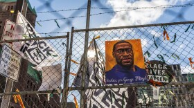 A poster with George Floyd's picture and a sign reads that "I Can't Breathe" hang from a security fence outside the Hennepin County Government Center on March 31, 2021 in Minneapolis, Minnesota. (Kerem Yucel/AFP via Getty Images)