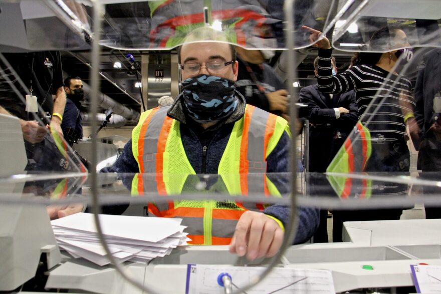 John Hansberry operates an extractor at Philadelphia’s ballot counting center at the Pennsylvania Convention Center. The machine removes sorted mail-in ballots from their double envelopes. Hansberry is using dummy ballots for this demonstration. No ballots can be legally opened before Election Day.