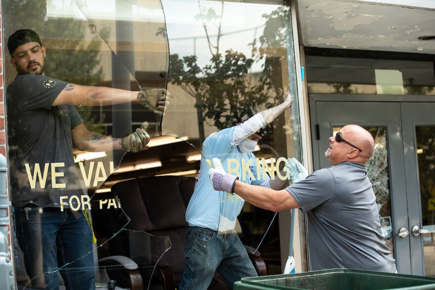 Volunteers work to clean up and repair damage at Kimbrell's Furniture, which was damaged and looted in downtown Raleigh, N.C. after a night of angry clashes between police and protestors left much of Downtown Raleigh damaged on Sunday, May 31, 2020. 