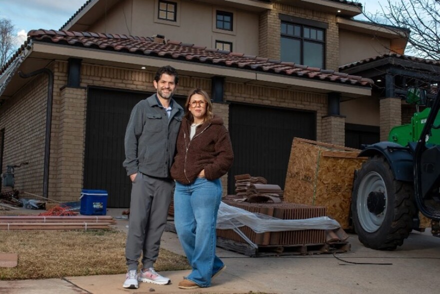 Craig and Elizabeth Gutierrez stand outside their Edmond home, which has been a construction site for the better part of a year.