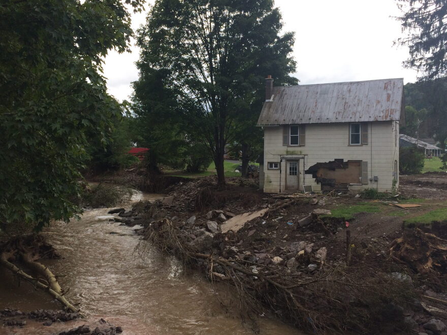 Overlooking the creek that had flooded, the retaining fence was ripped from the side of the creek.