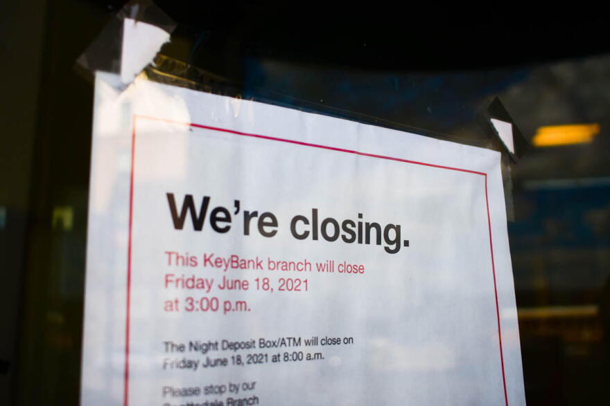 A sign on the front of a former KeyBank branch in South Bend warns customers it will be closing.