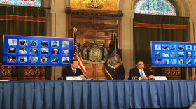 Gov. Andrew Cuomo displays photos of some of the New Yorkers whose lives were taken by the virus at Wednesday's briefing.