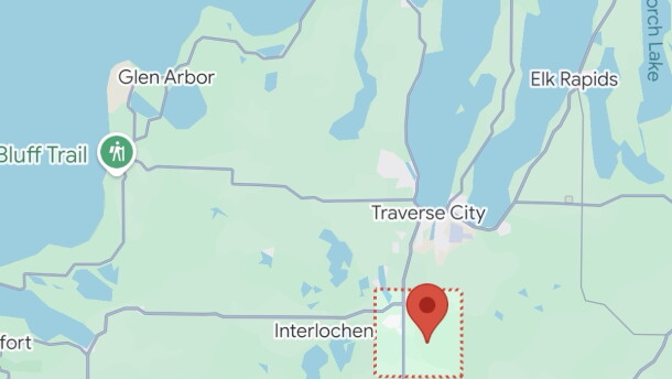A map shows a pin dropped within a red box near Interlochen and Traverse City.