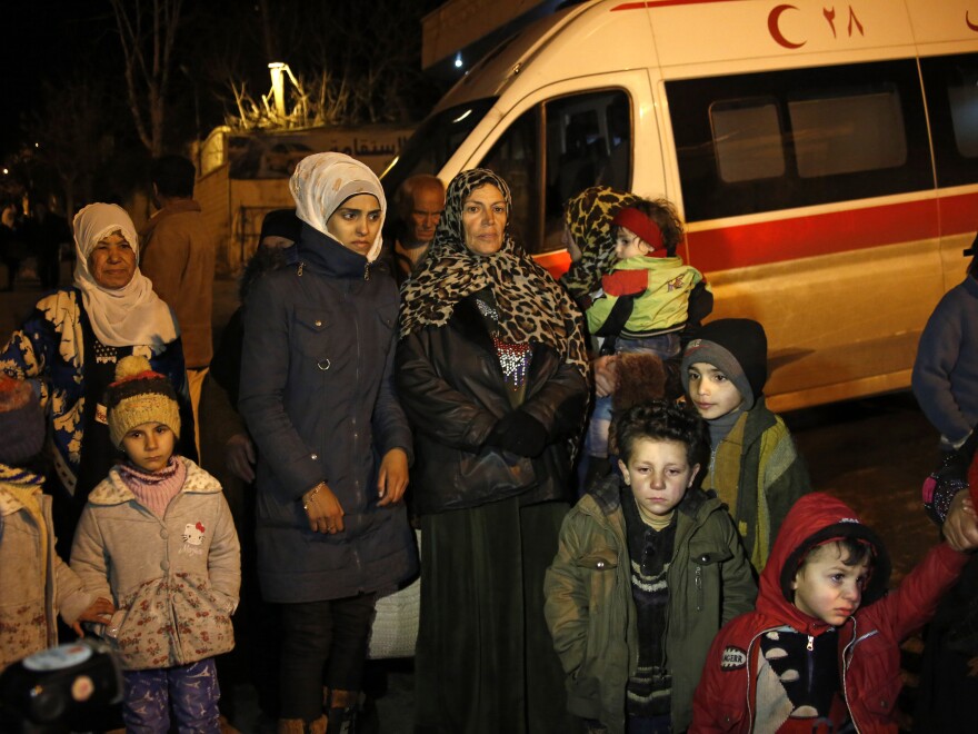 People wait to leave the besieged town of Madaya, northwest of Damascus, Syria, on Jan. 11.