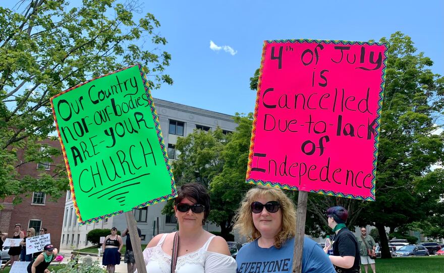 Heather Marie Brown and Jennifer Blair said they wanted to show their frustration with actions taken at both the federal and state level to limit access to abortion. Brown said she was troubled by Gov. Chris Sununu's decision to sign a 24-week abortion ban last year. Sununu has since backed some exceptions to that ban, but Brown said she wished he hadn't signed it to begin with.