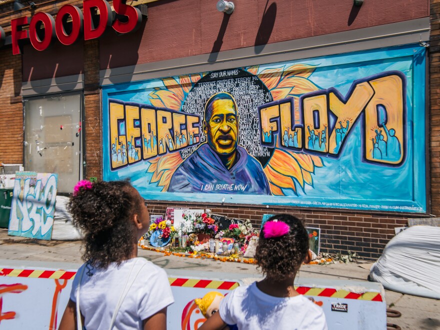 Jordan and Royal Pacheco view a mural of George Floyd in Minneapolis on Friday, as a Hennepin County court weighed the sentence to impose on former police officer Derek Chauvin.
