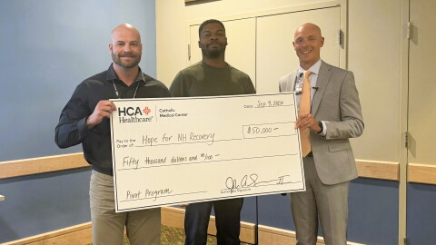 Randy Stevens and Ethan Lendore of Hope for NH Recovery accept a check from CMC Chief Executive Officer John Skevington.