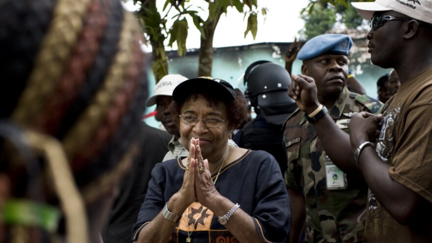 <p>Liberian President Ellen Johnson Sirleaf addresses a crowd of supporters on Saturday outside offices of her party on the outskirts of Monrovia, Liberia's capital. She faces Winston Tubman in a runoff election scheduled for Nov. 8. </p>