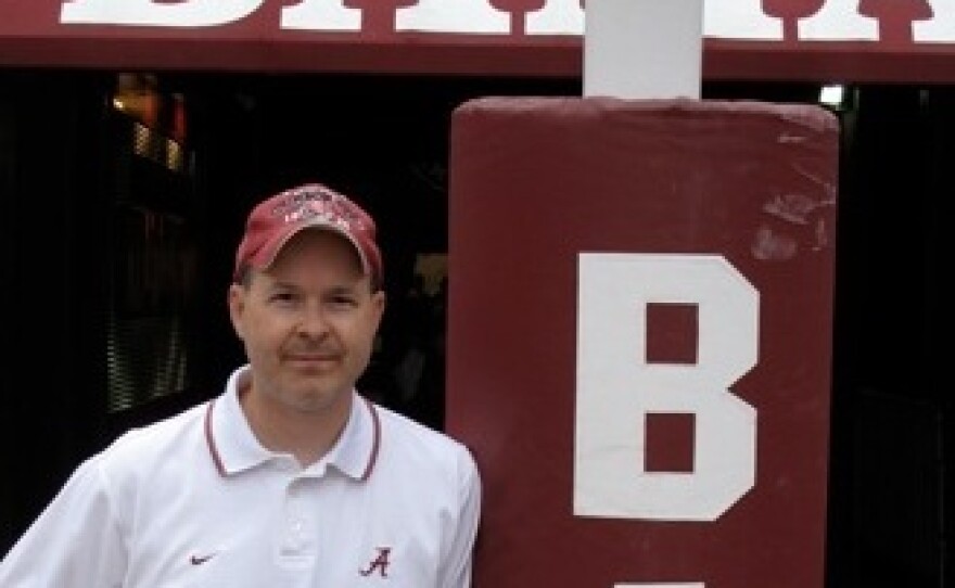 Monique Fields, an unofficial, unpaid football assistant, snapped this picture of her husband, Ken, standing at the goalpost at Bryant-Denny Stadium.