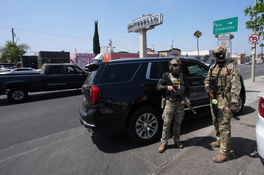 FILE: Immigration agents conduct an operation at a car wash, Aug. 15, 2025, in Montebello, Calif.