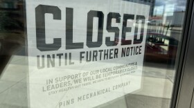 A "closed" sign is posted on a closed duckpin bowling alley and bar in downtown Columbus.