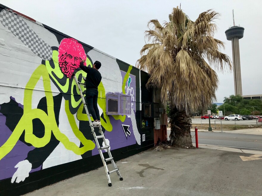 James Medrano working on his mural