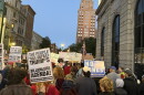 Protestors march through Syracuse holding signs