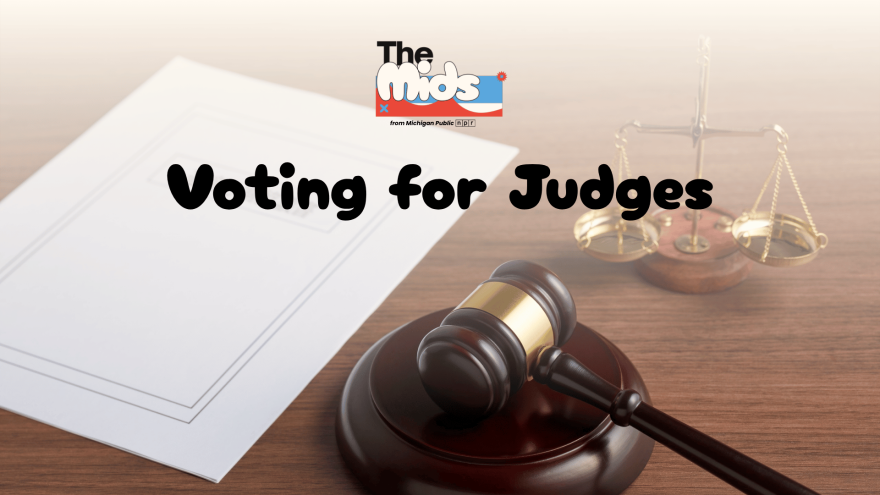 A gavel, balance and piece of paper are on a wooden desk. In front of them is a light orange, gradient background with The Mids logo. Underneath the logo are the words "Voting for Judges."
