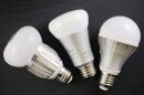FILE - Three LED bulbs, from left to right, the GreenWave Reality, Philips Hue, and TorchStar, are arranged for a photo.