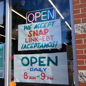 Signage showing that the USDA Supplemental Nutrition Assistance Program (SNAP) is accepted is displayed at Wild Onion Market, Monday, Oct. 27, 2025, in Chicago. (AP Photo/Erin Hooley)