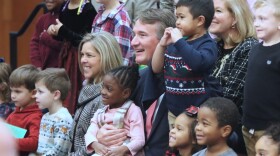 First Lady of Virginia Suzanne Youngkin and Virginia Gov. Glenn Youngkin posing with children for a photo following a press conference in Richmond on Dec. 7, 2023. (Nathaniel Cline/Virginia Mercury)