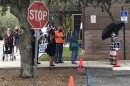 Early voters wait in line Monday at the Regency Branch of the Jacksonville Public Library.