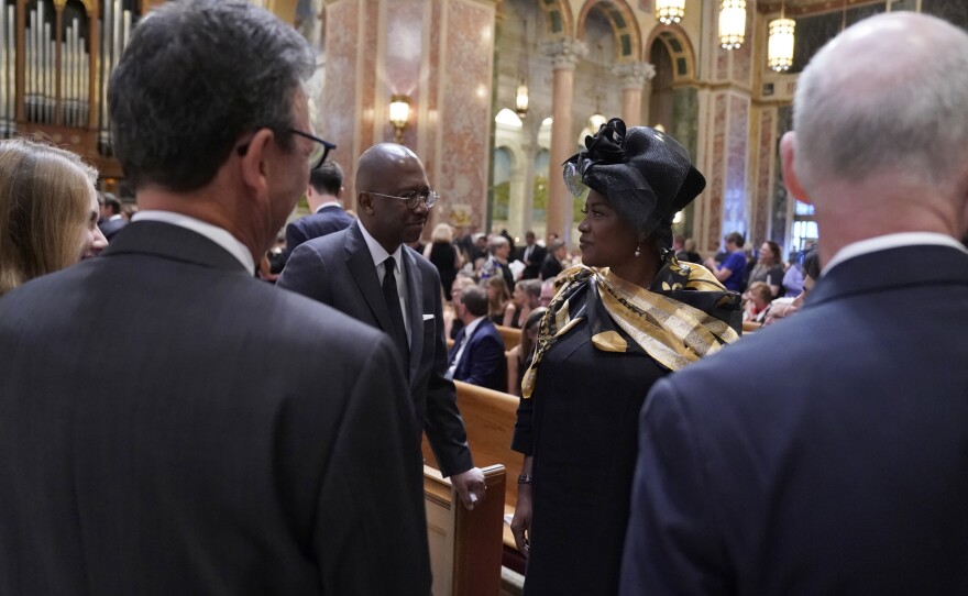 Pierre Thomas, left and Donna Brazile talk at Cokie Roberts' funeral.