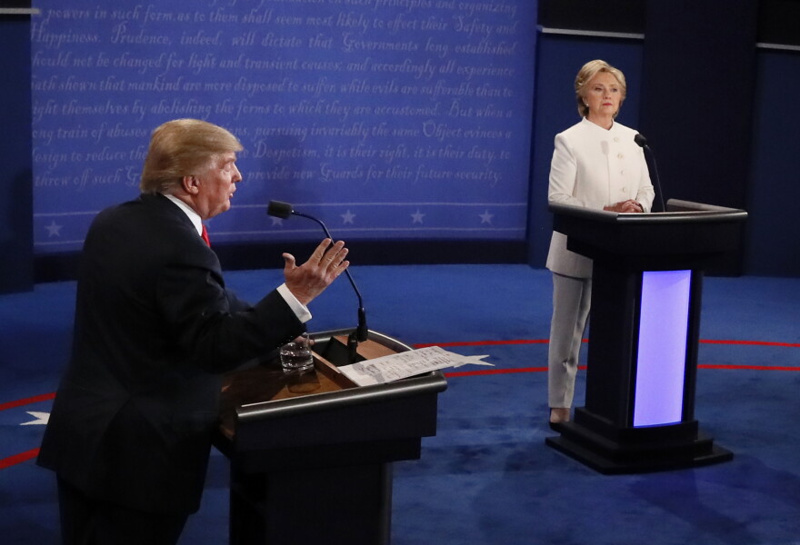 Republican nominee Donald Trump (L) gestures as Democratic nominee Hillary Clinton looks on during the final presidential debate at the Thomas & Mack Center on the campus of the University of Las Vegas in Las Vegas on Oct. 19, 2016.