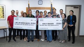 Two new homeowners receive their ceremonial checks for closing on their mortgage through the Hale Kamaʻāina Mortgage Program on May 7, 2026.