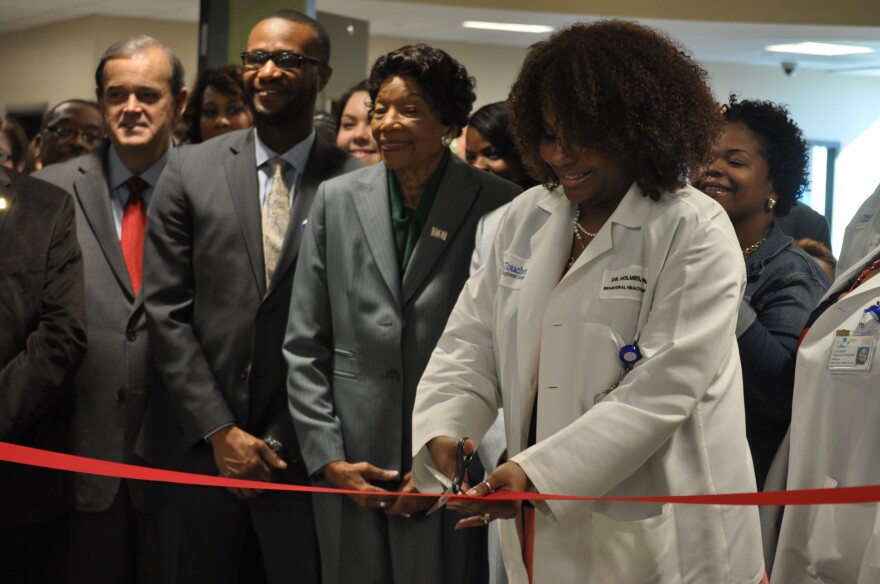 Director Desarie Holmes cuts a ribbon to mark the opening of Behavioral Health Services at Touchette Regional Hospital in Centreville.