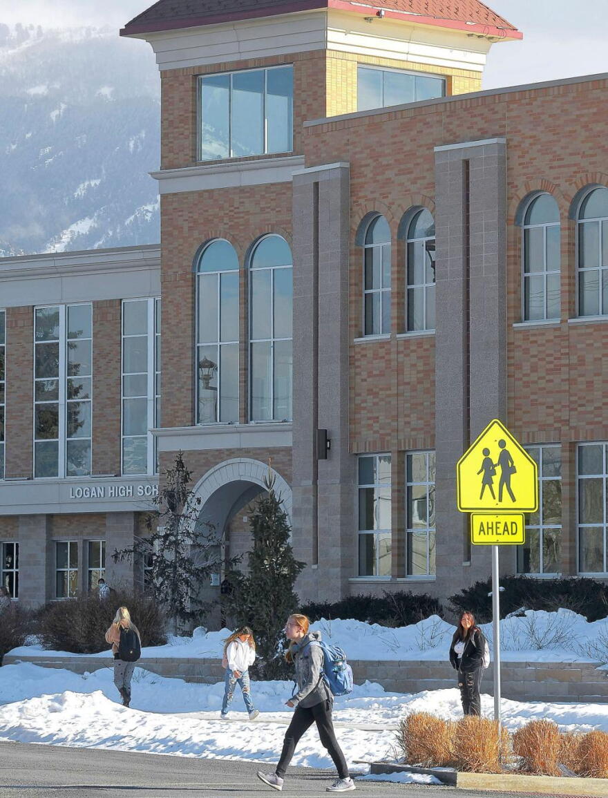 Students walk past Logan High School on Wednesday afternoon.