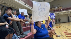 Mercer County residents hold up signs protesting a proposed data center at a planning and zonign commission meeting in Harrodsburg on July 30.