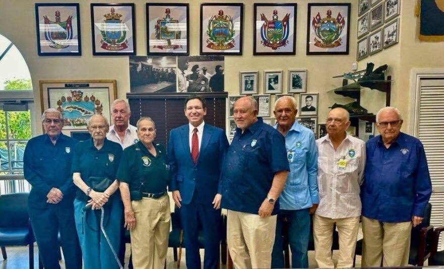 Ron DeSantis smiling next to a group of people