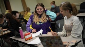 Students Camryn Robinson, left, and Adeline Harrell work together on an in-class project in their "Rhetoric of Walt Disney World" class at New College of Florida, Thursday, March 2, 2023, in Sarasota, Fla. The academic freedom that allows students to design individualized majors is mirrored by a student body that feels free to express itself, say students and faculty, who describe New College as a haven for brainy kids who are high-achieving and intellectually curious. (AP Photo/Rebecca Blackwell)