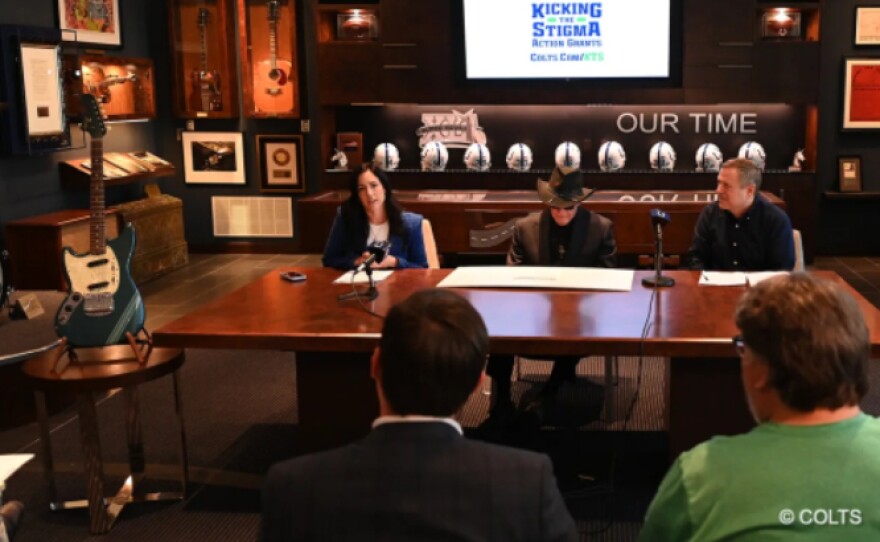 Jim Irsay, CEO and Owner of the Colts, and Kalen Jackson, Vice Chair/Owner of the Colts, with the guitar.