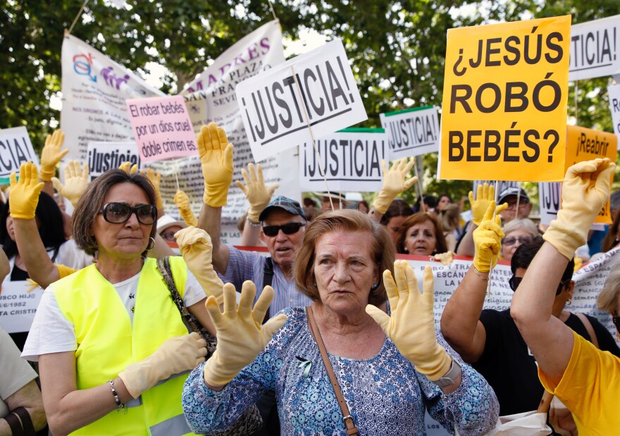 Spaniards take part in a protest over Spain's stolen babies scandal outside a court in Madrid, on June 26. No Spanish government has acknowledged the alleged cases.