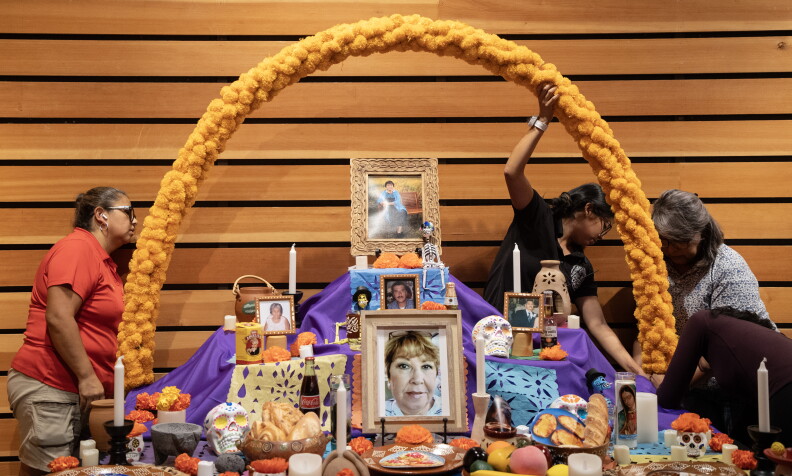 A family sets up an ofrenda for the Dia de los Muertos celebration this weekend at the Naples Botanical Garden. Attendees can see the ofrendas from several families and add their own memories to an interactive exhibit.