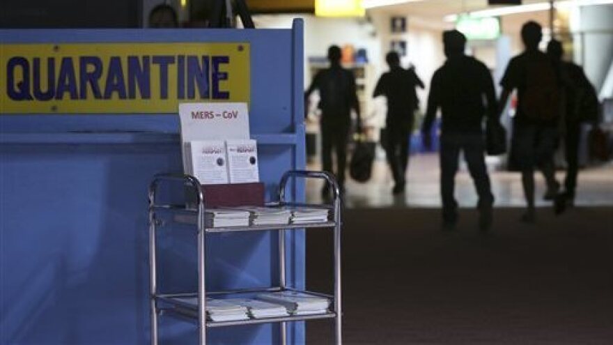 In this photo from 2014, passengers walk past the Middle East respiratory syndrome quarantine area at Manila's International Airport in the Phillipines. The virus is now raising public concern in South Korea.