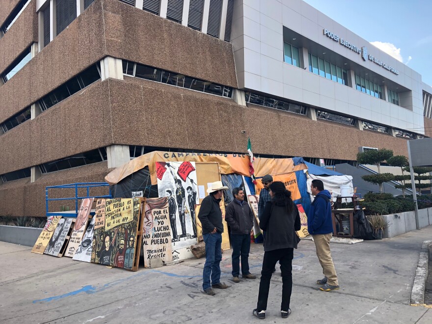 Mexicali Resiste members chat outside their encampment in front of Baja California's government offices in Mexicali. From left to right, Alberto Salcido, Francisco Javier Trujillo, Mauricio Villa, Jesus Galaz Duarte and Jorge Benitez.