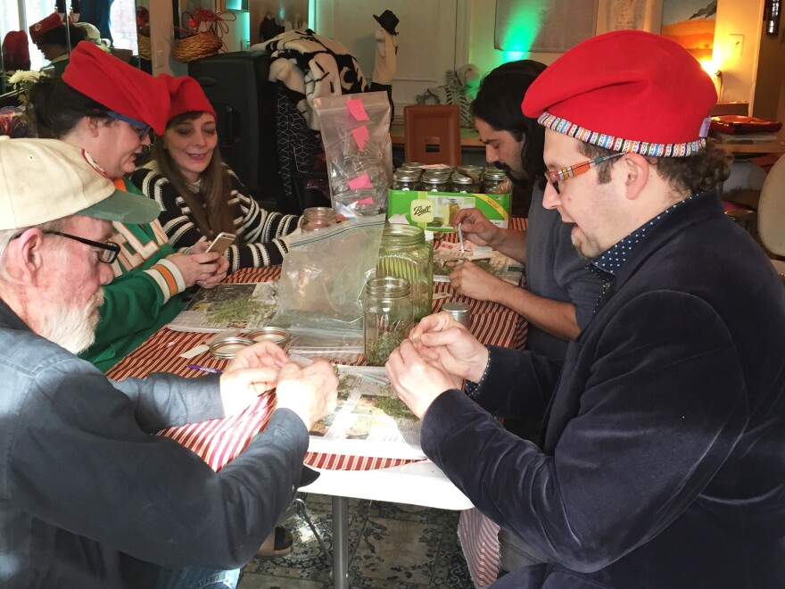 Adam Eidinger (at right, in hat), a leader of DC Cannabis Coalition, and other volunteers roll marijuana joints they plan to hand out for free on Inauguration Day.