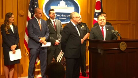 Representatives Kent Smith (left) and Tim Schafer (right) with backers of their bill behind them.