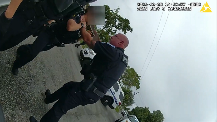 A screen capture of a body cam footage from November shows a Sunrise police sergeant grabbing a female officer by the throat.