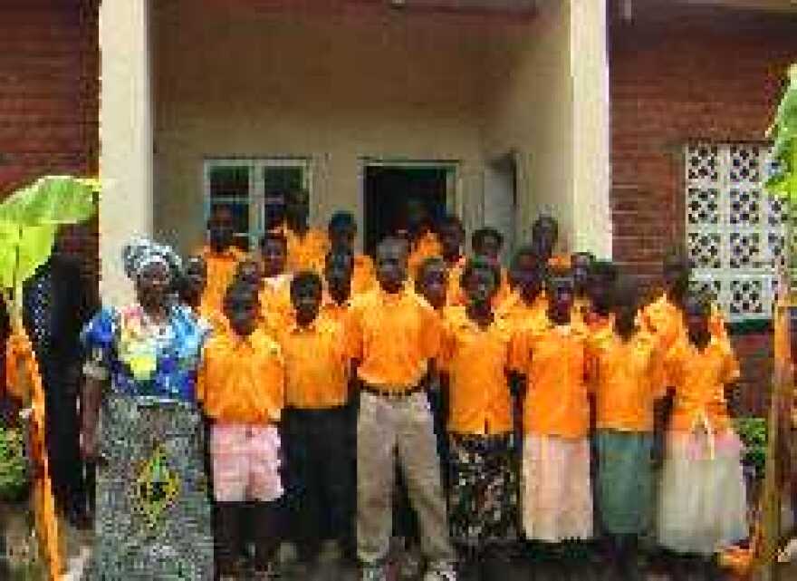 Mai (Mama) Deborah Naybor Building and new students of the first ever secondary school in Dumasi, Malawi, Africa, and founder of the Joyce Banda Foundation School, Mrs. Joyce Banda.