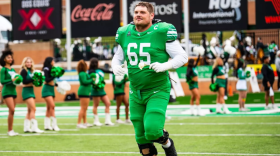 North Texas offensive lineman Gabe Blair runs onto the field during Senior Day ceremonies before UNT’s win over Temple at DATCU Stadium.