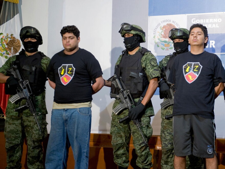 Alleged drug traffickers Christopher Fuentes Letelier (second from left) and Rafael Bautista Delgado (right) are presented to the press in Mexico City on Sept. 9. The two are alleged members of Los Zetas, a notoriously dangerous drug cartel founded by 31 elite Mexican army anti-narcotics commandos.