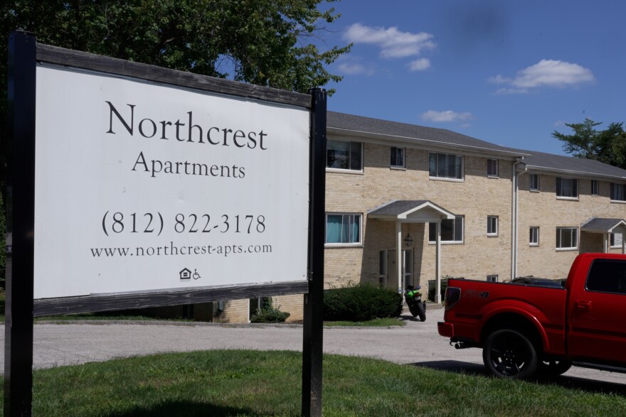 A limestone apartment complex with a sign that says Northcrest
