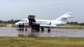 The Private's body is carried by an honor guard from an airplane at Tulsa's Air Guard Base.