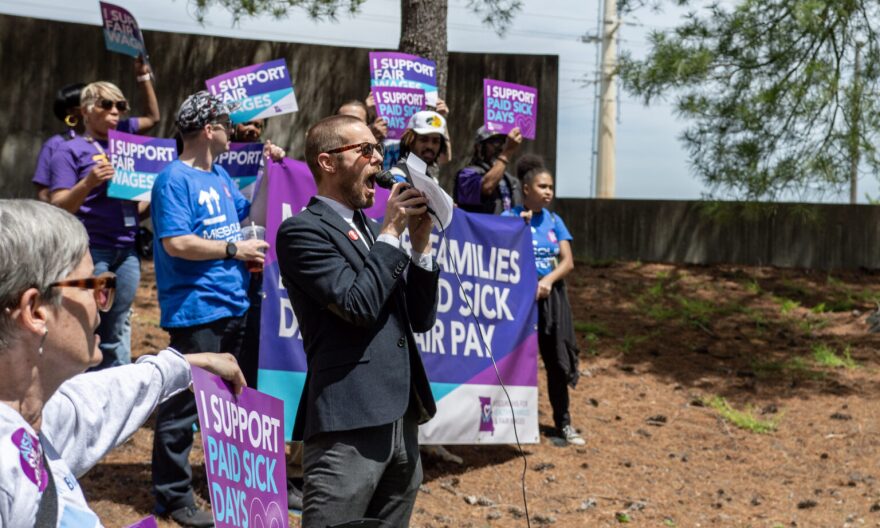 Daniel Tucker, a leader with the Missouri Workers Center, teaches chants customized to an initiative petition to raise the minumum wage and mandate paid sick leave outside of the Secretary of State's office building in Jefferson City Wednesday.