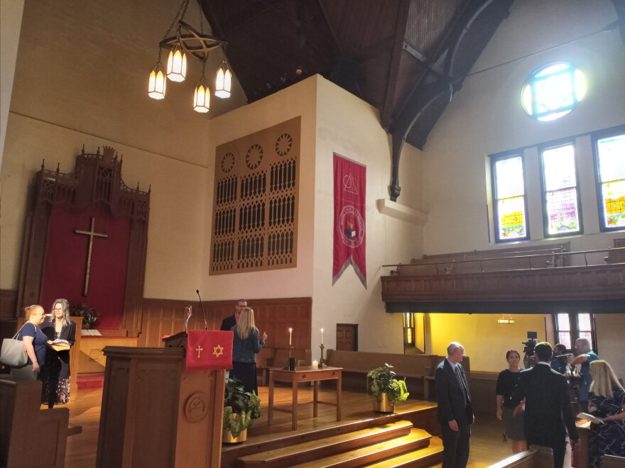 Attendees and speakers in Drury's Stone Chapel, winding down at the interfaith prayer's conclusion