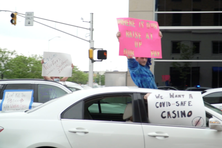 Casino workers hold signs from their cars in downtown Indianapolis.